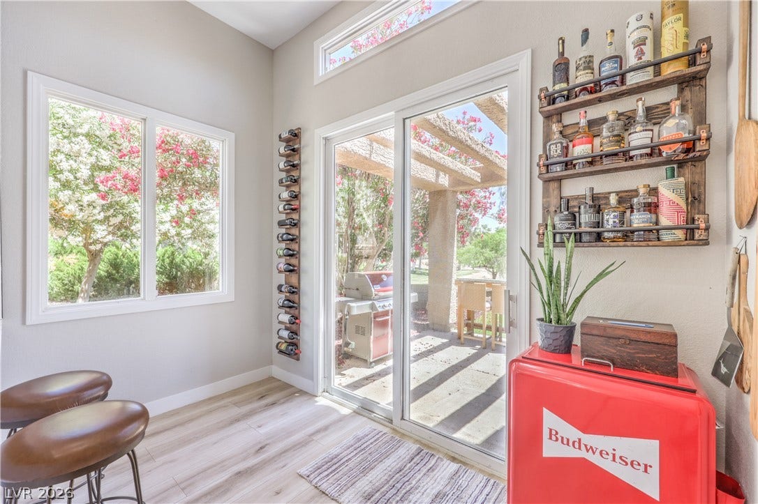 8211 Round Hills Circle, Las Vegas, NV 89113 This bright space features sleek flooring, a window providing a natural view, and a glass slider leading to an outdoor living area.