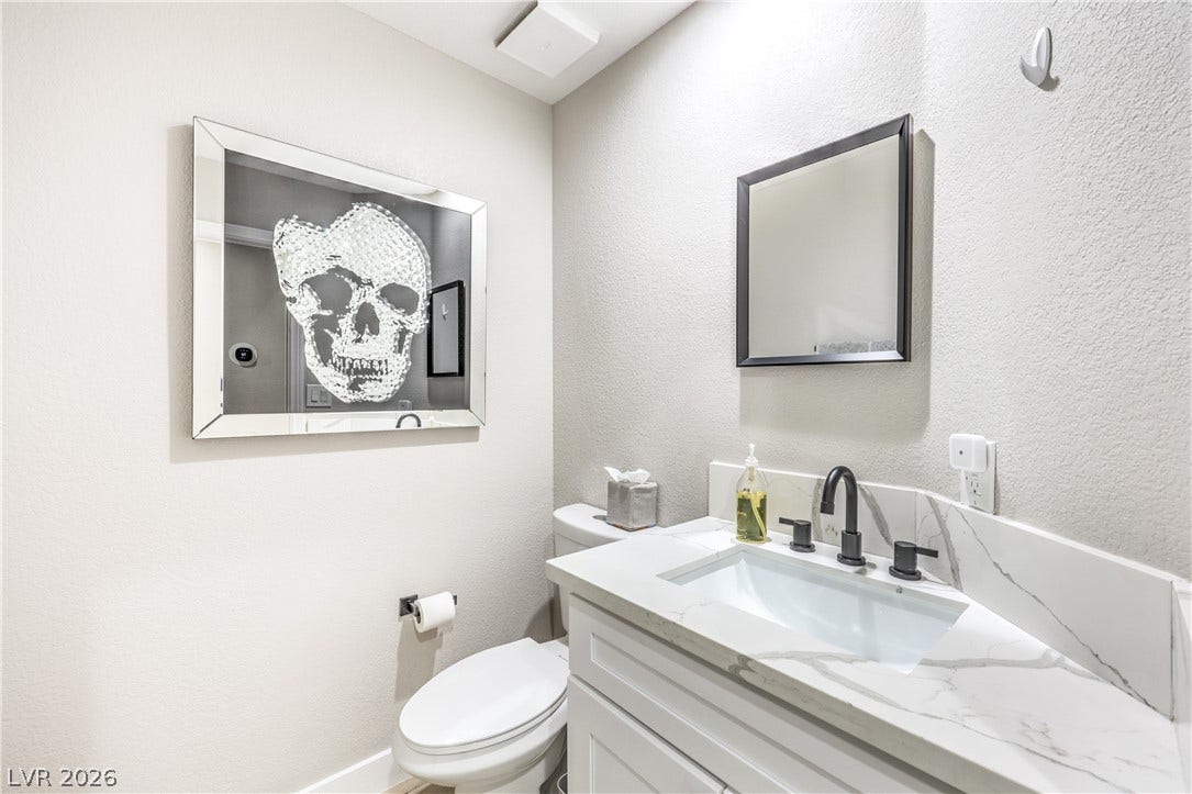 8211 Round Hills Circle, Las Vegas, NV 89113 This guest bath features a sleek vanity with ample counter space and a modern fixture.