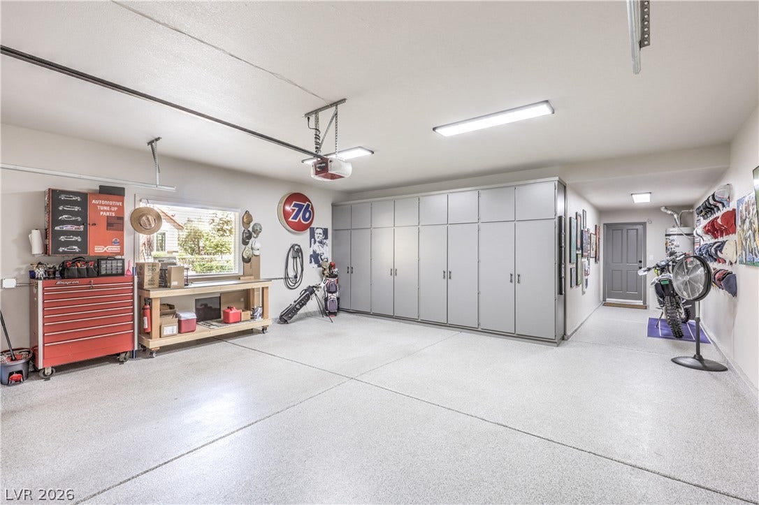 8211 Round Hills Circle, Las Vegas, NV 89113 This spacious garage features abundant built-in storage, bright overhead lighting, and durable flooring.