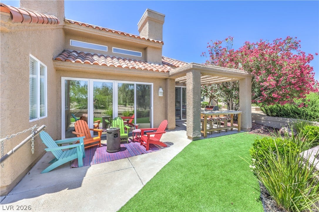 8211 Round Hills Circle, Las Vegas, NV 89113 This private patio offers a comfortable outdoor retreat with an inviting grilling station and ample space for relaxation.