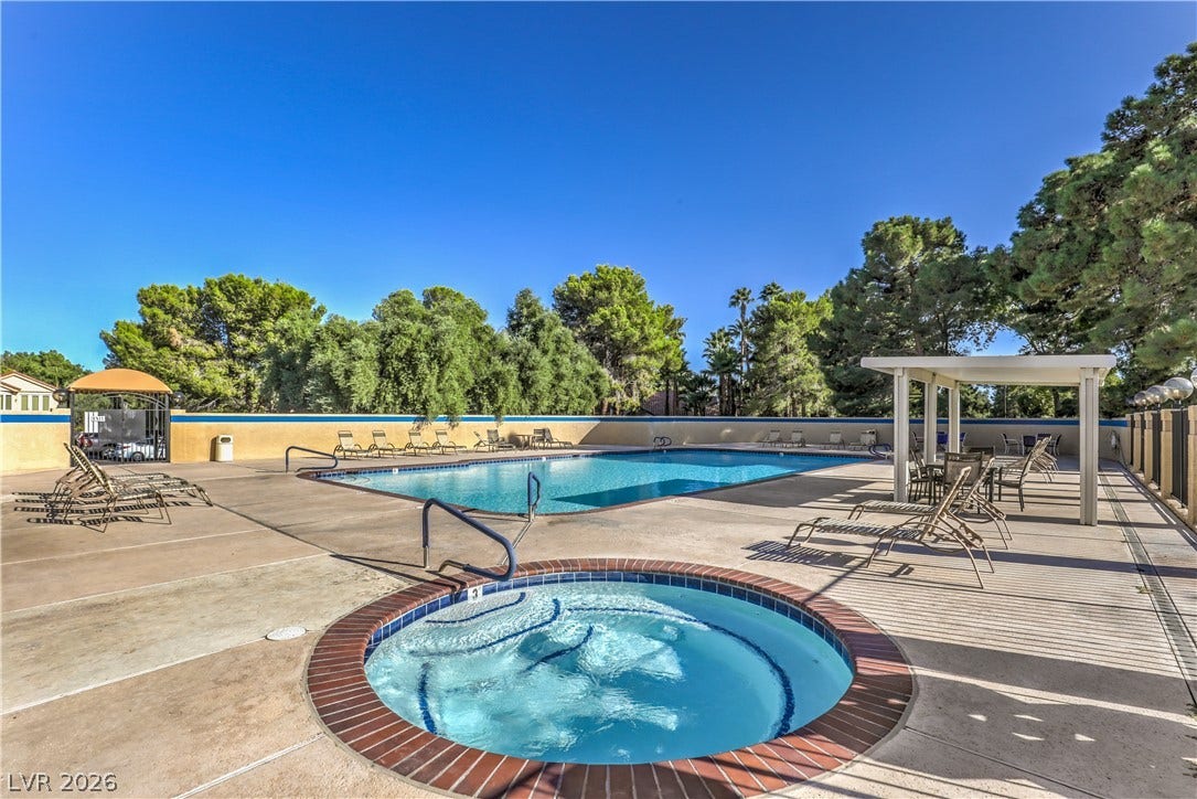 8211 Round Hills Circle, Las Vegas, NV 89113 Relax and unwind in this inviting outdoor oasis featuring a sparkling pool and adjacent spa.