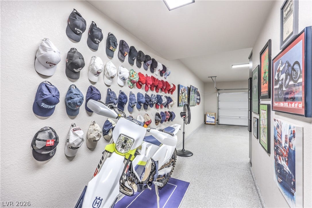 8211 Round Hills Circle, Las Vegas, NV 89113 This spacious, well-lit garage features epoxy flooring and ample wall space for decor.