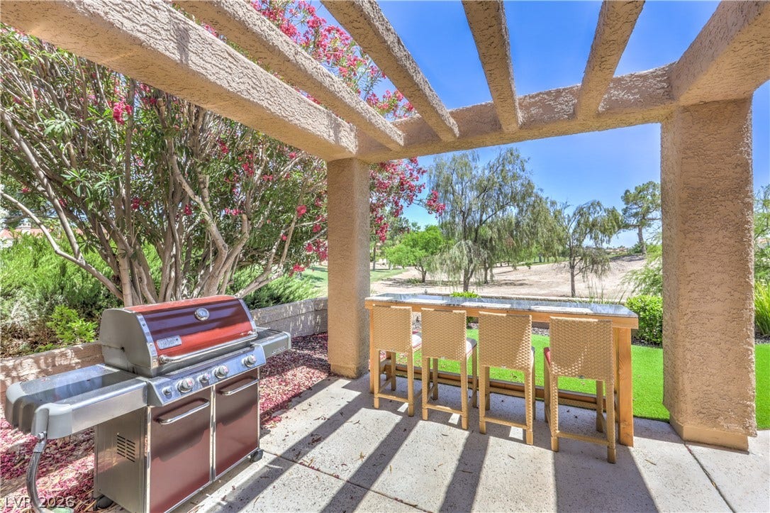 8211 Round Hills Circle, Las Vegas, NV 89113 This private patio offers a relaxing outdoor dining space and beautiful views of the surrounding landscape.