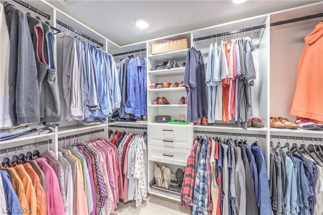 8211 Round Hills Circle, Las Vegas, NV 89113 This California custom-designed walk-in closet offers extensive storage with integrated shelving and hanging rods for optimal organization.