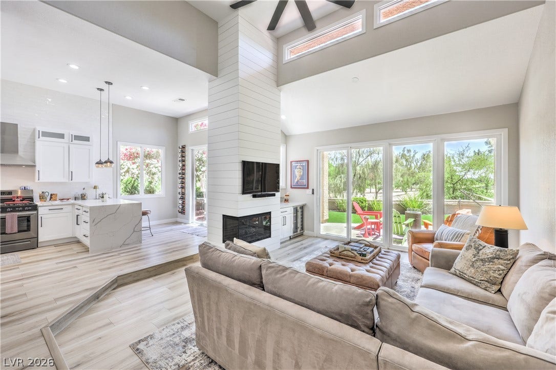8211 Round Hills Circle, Las Vegas, NV 89113 This living space and kitchen flow together seamlessly, bathed in light with an alluring view of the outdoors.