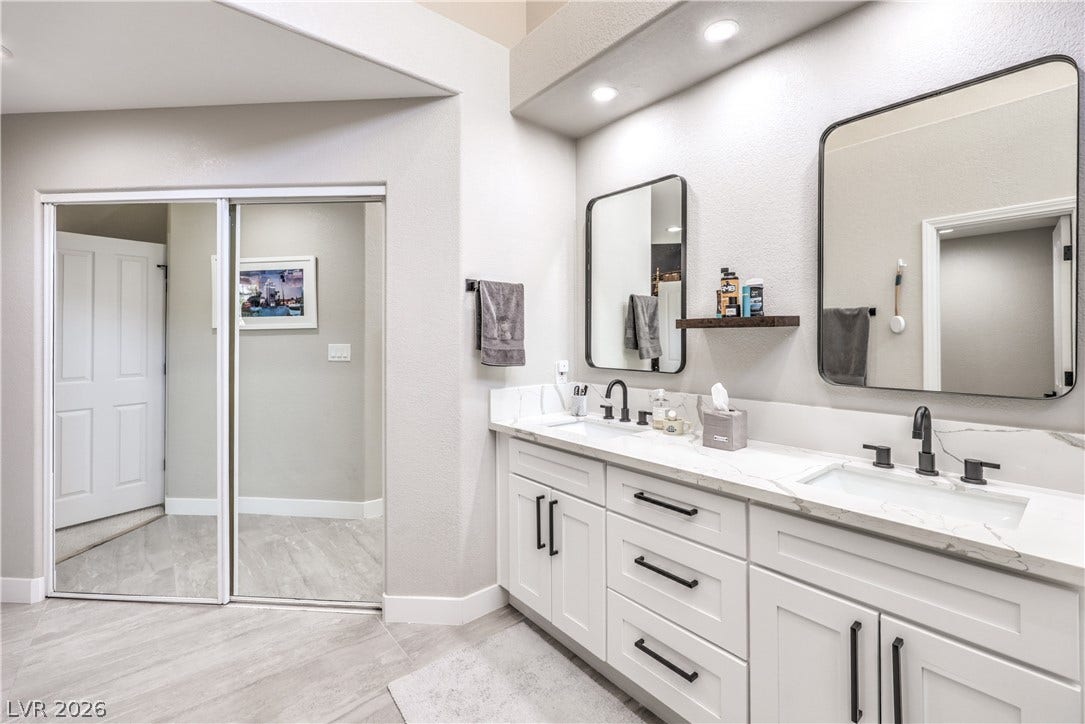 8211 Round Hills Circle, Las Vegas, NV 89113 This primary bathroom features a double vanity with ample storage and sleek, modern fixtures.