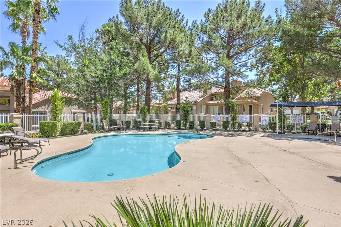 8211 Round Hills Circle, Las Vegas, NV 89113 Enjoy leisurely days by this community pool, surrounded by mature trees and lush landscaping.