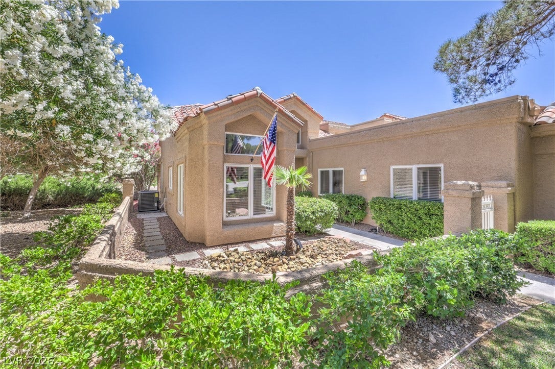 8211 Round Hills Circle, Las Vegas, NV 89113 This residence showcases a Mediterranean-inspired architectural style with mature landscaping, offering appealing curb presence.