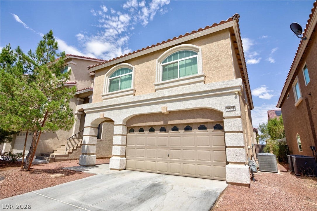9804 Kodiak Island Court, Las Vegas, NV 89141 Spanish tile roofing and architectural arches define this multi-level stucco exterior.