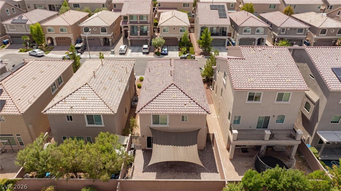 9804 Kodiak Island Court, Las Vegas, NV 89141 Multi-level homes feature tiled roofs and fenced yards within a developed neighborhood setting.