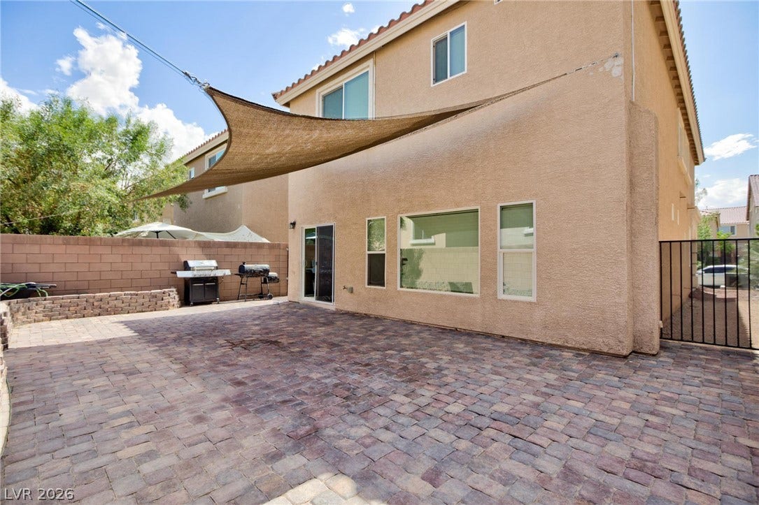 9804 Kodiak Island Court, Las Vegas, NV 89141 A spacious brick paver patio lines the back of this two-story stucco home.