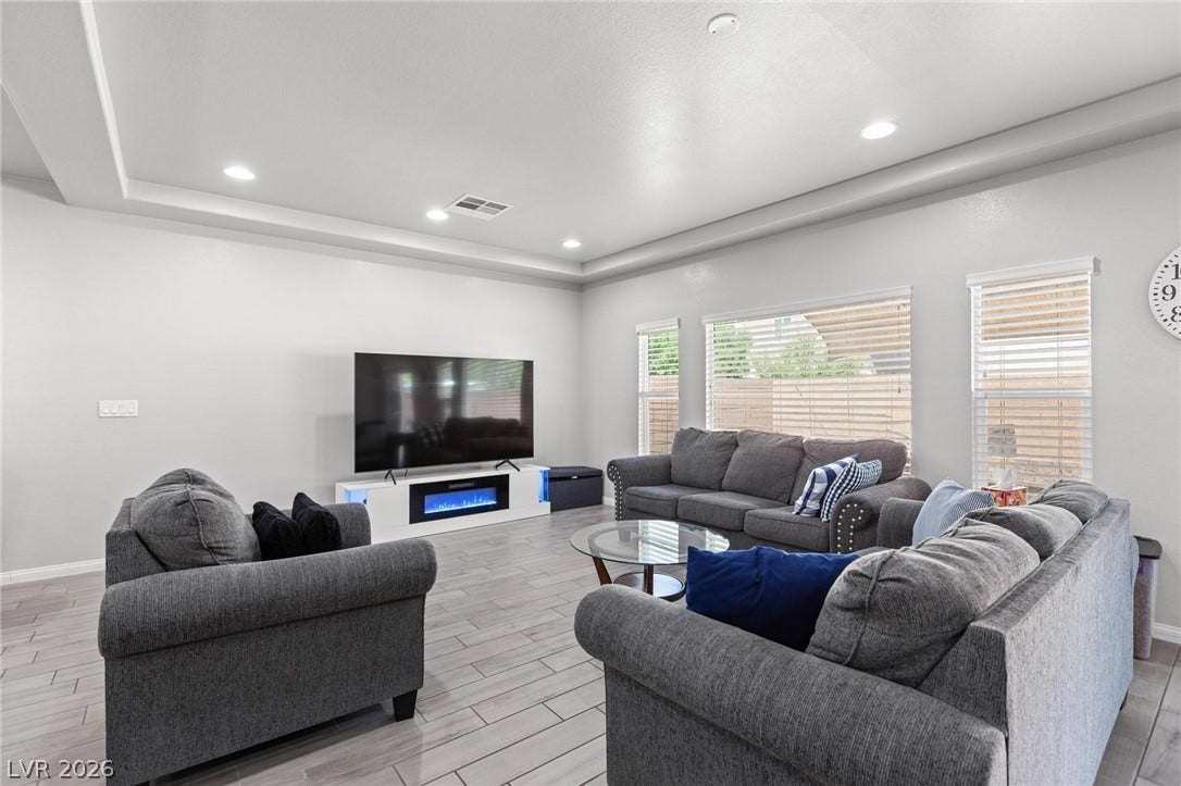 9804 Kodiak Island Court, Las Vegas, NV 89141 An elegant tray ceiling and durable tile flooring define this spacious living area.