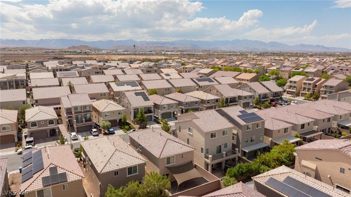 9804 Kodiak Island Court, Las Vegas, NV 89141 A sweeping aerial view showcases the surrounding neighborhood under vast desert skies.