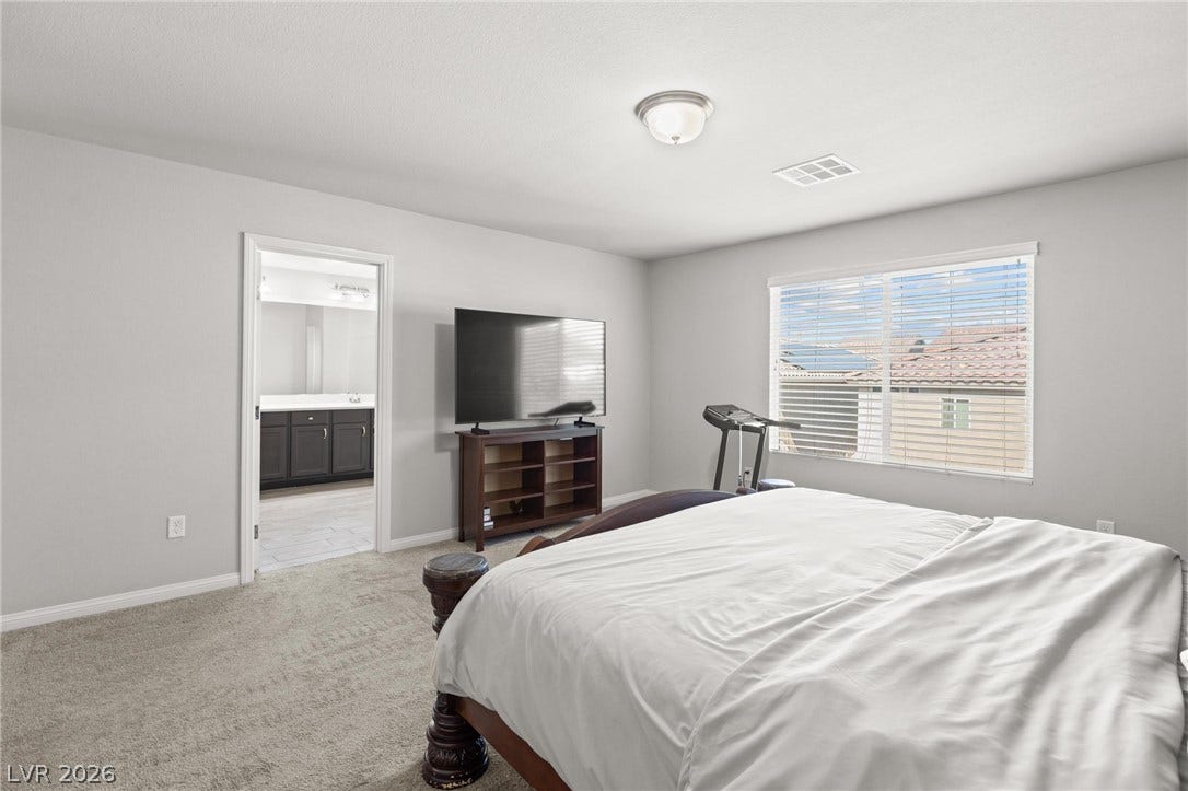 9804 Kodiak Island Court, Las Vegas, NV 89141 Plush carpeting and a large window with neighborhood views define this tranquil bedroom retreat.