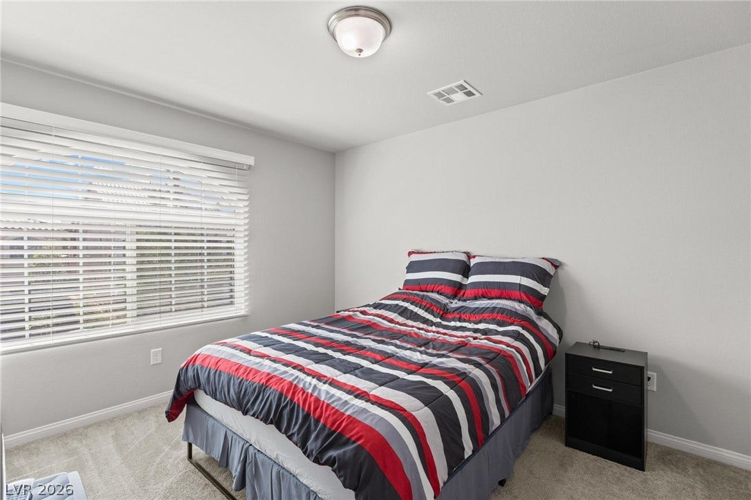 9804 Kodiak Island Court, Las Vegas, NV 89141 Plentiful natural light streams across soft carpeting in this comfortable bedroom space.