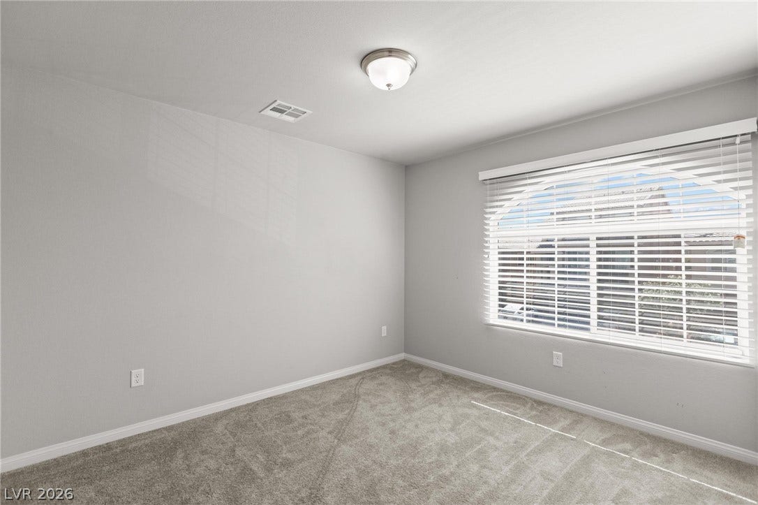 9804 Kodiak Island Court, Las Vegas, NV 89141 Soft carpeting pairs with a large window in this peaceful bedroom.