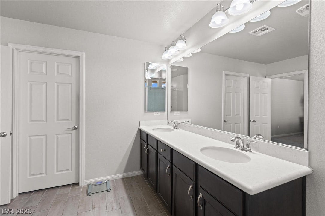 9804 Kodiak Island Court, Las Vegas, NV 89141 A spacious double vanity anchors this modern bathroom featuring durable tile flooring.