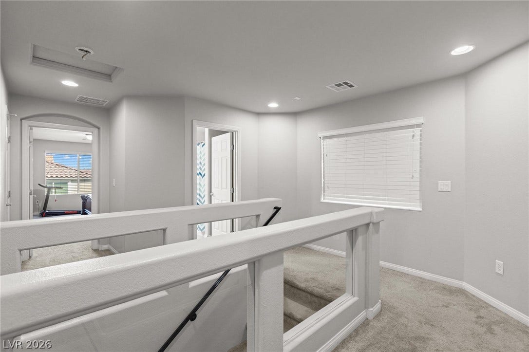 9804 Kodiak Island Court, Las Vegas, NV 89141 Plush carpeting anchors this versatile upstairs landing flanked by modern railings and recessed lighting.