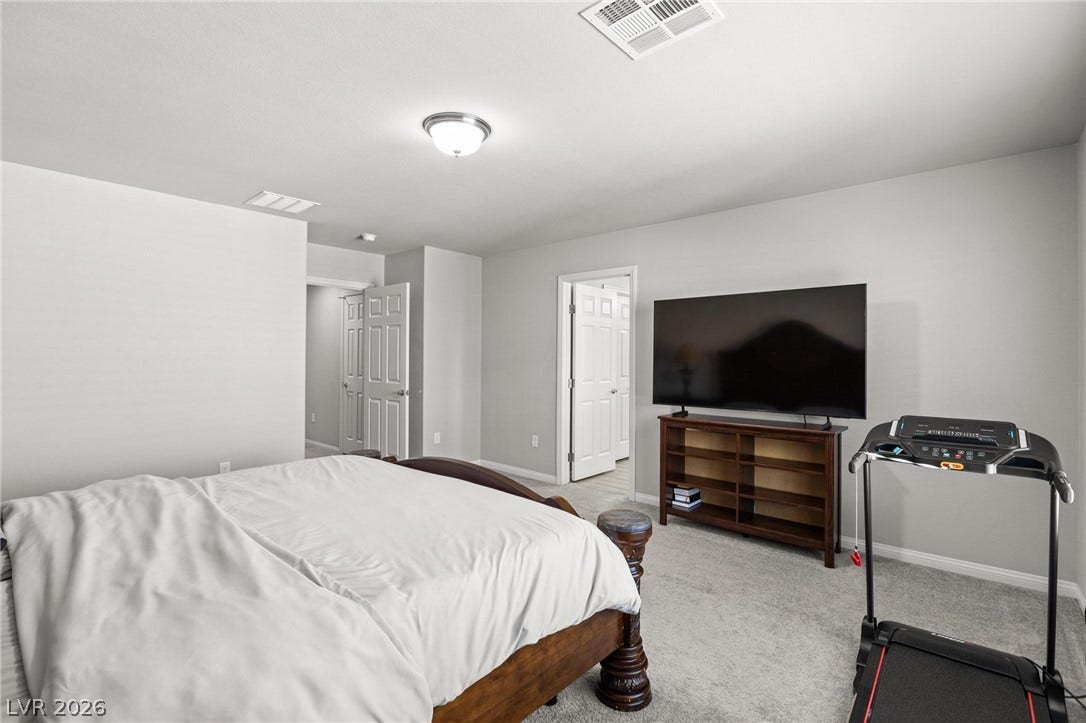 9804 Kodiak Island Court, Las Vegas, NV 89141 Plush carpeting underfoot complements the smooth walls and classic panel doors of this comfortable space.