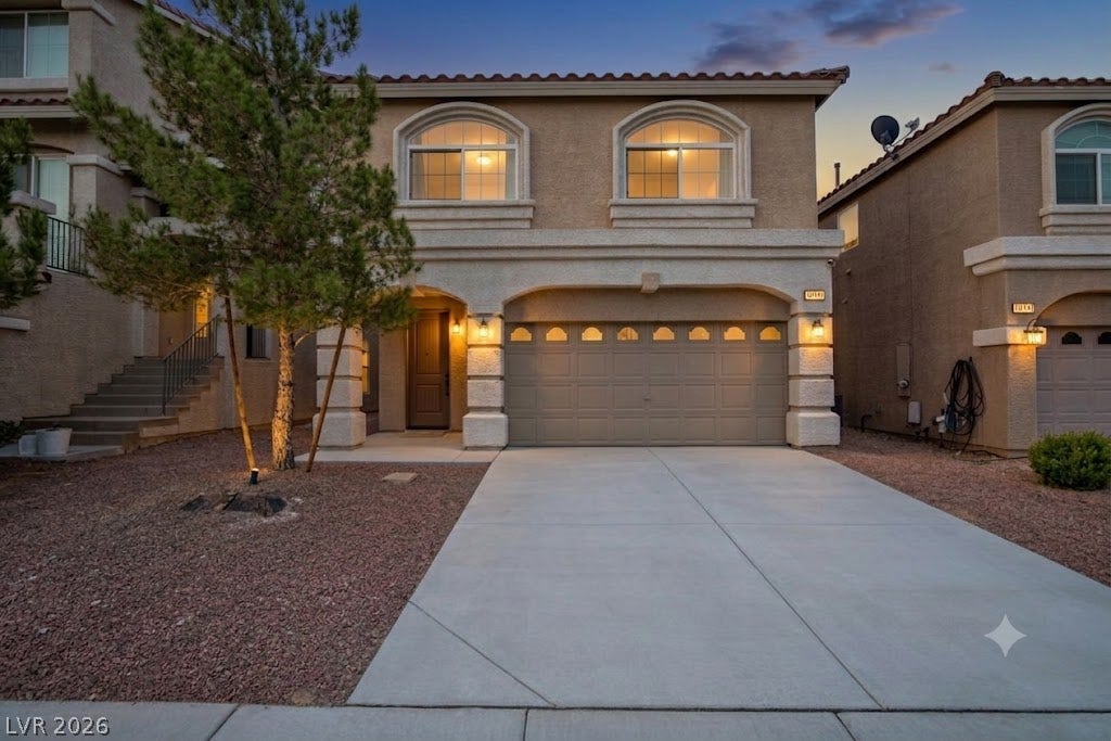 9804 Kodiak Island Court, Las Vegas, NV 89141 Arched windows and a spacious two-car garage highlight the Mediterranean-style exterior architecture.