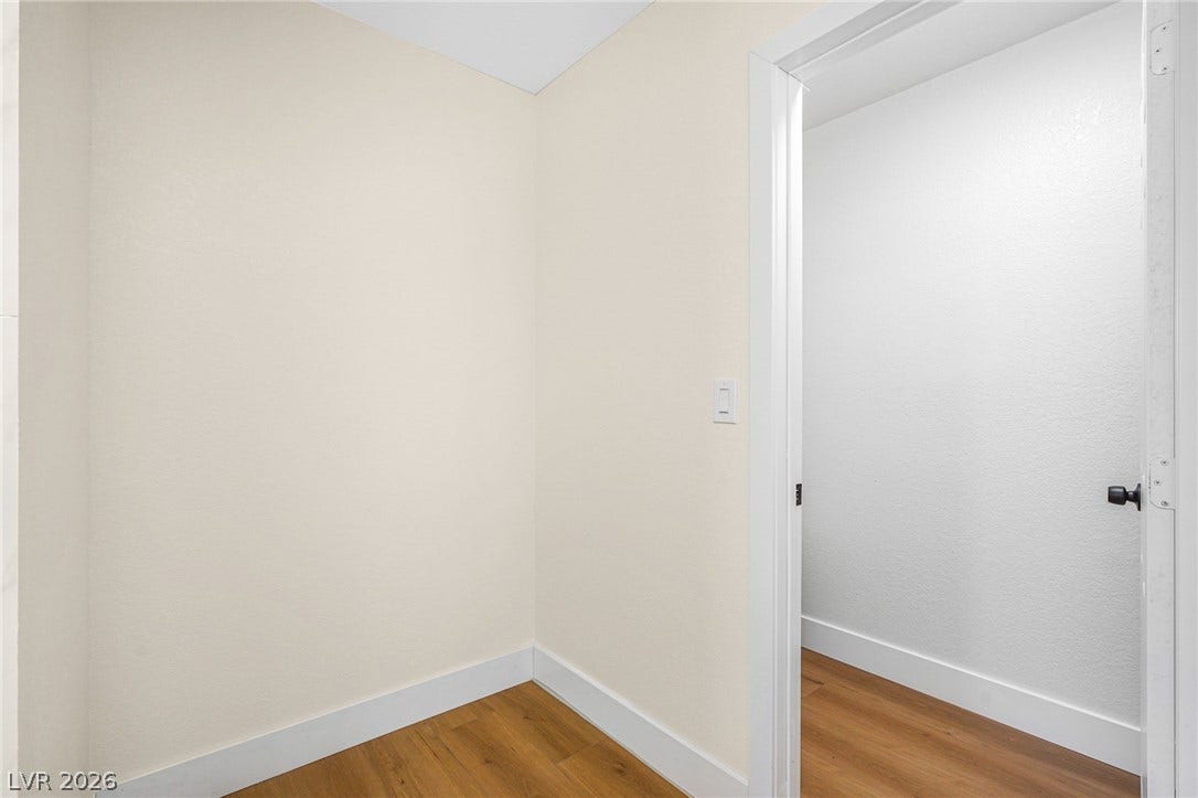 Smooth plaster walls and warm wood flooring define this versatile interior transition space.
