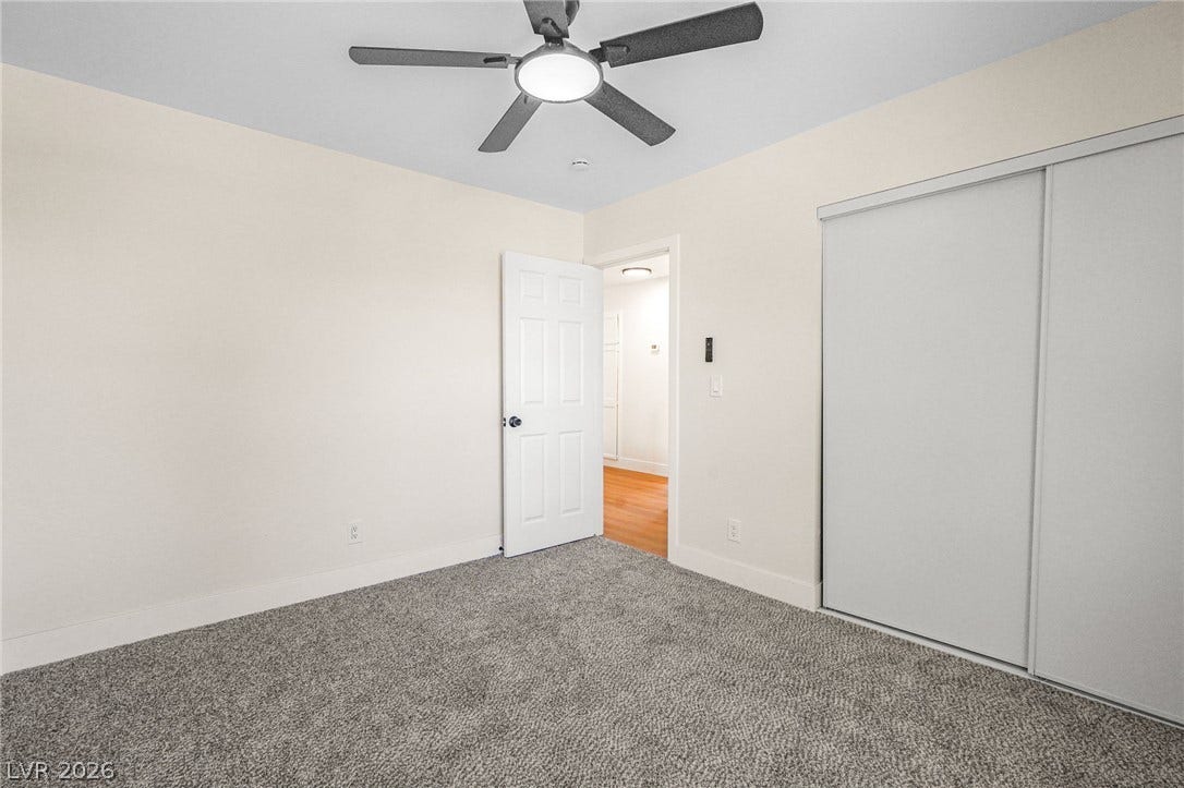 Soft carpeting underfoot defines this inviting bedroom featuring sliding closet doors.