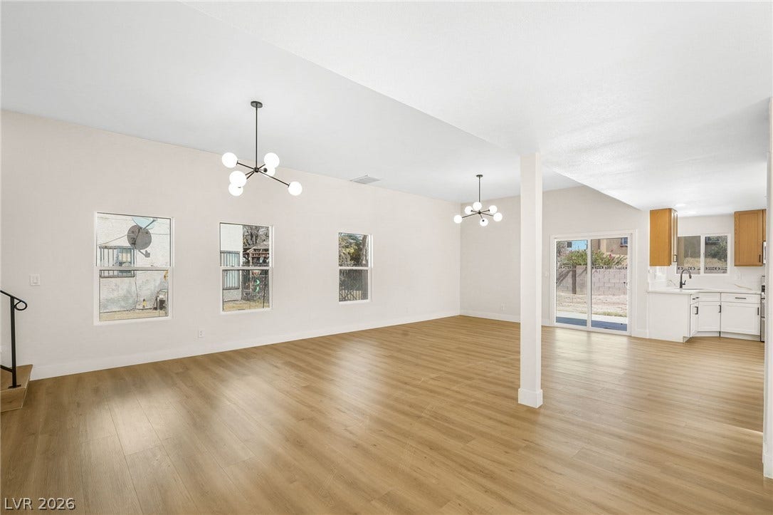 Seamless flow connects the spacious living area to the adjacent kitchen and back patio.