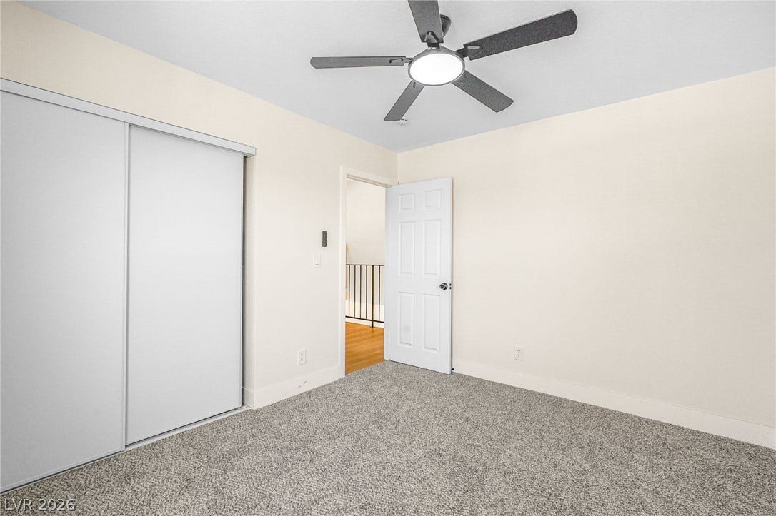 Plush carpeting underfoot complements the neutral walls of this versatile secondary bedroom.