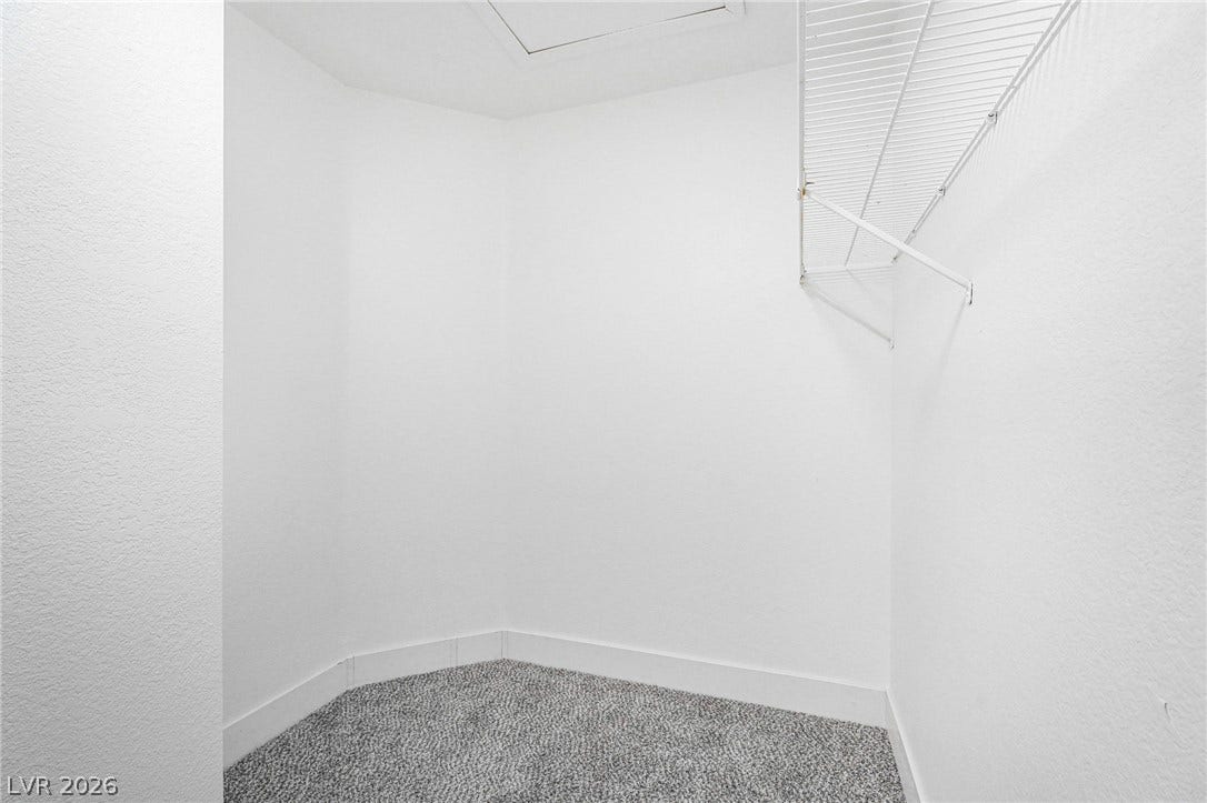 Ample storage potential awaits in this clean, carpeted closet space with integrated shelving.