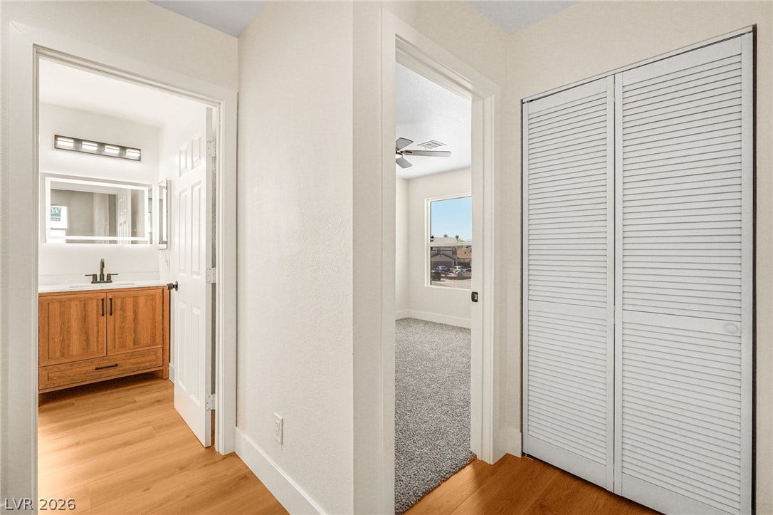 Clean lines and smooth transitions connect the hallway to the adjacent bedroom and bathroom.