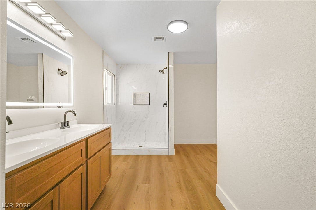 Clean lines and a spacious walk-in shower define this modern bathroom space.