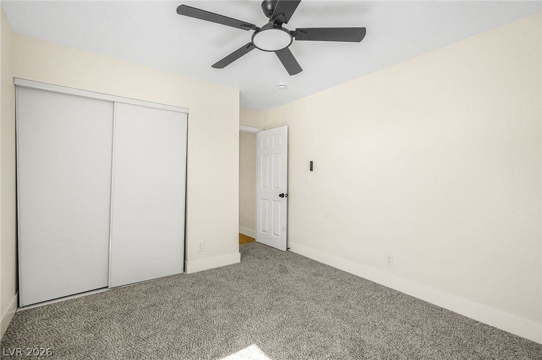 Soft carpeting underfoot creates a comfortable atmosphere in this versatile bedroom space.
