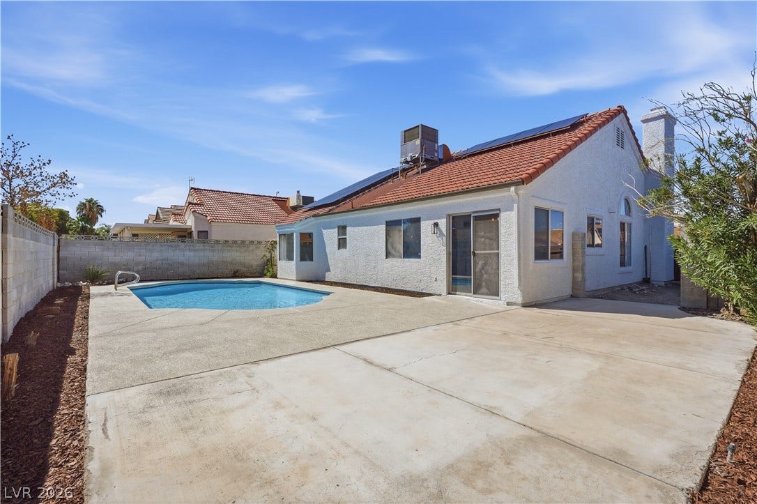 1013 Greystone Drive, Las Vegas, NV 89108 An inviting backyard oasis features a sparkling swimming pool, spacious concrete patio, and tile roof.
