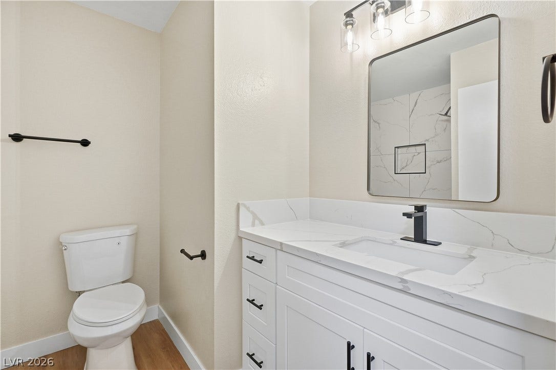 1013 Greystone Drive, Las Vegas, NV 89108 Elegant quartz vanity tops pair beautifully with sleek black fixtures in this refined space.