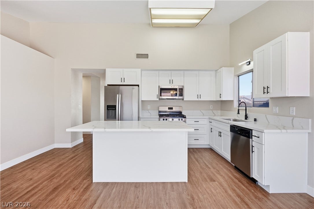 1013 Greystone Drive, Las Vegas, NV 89108 Gleaming stone countertops and a central island anchor this modern culinary space.