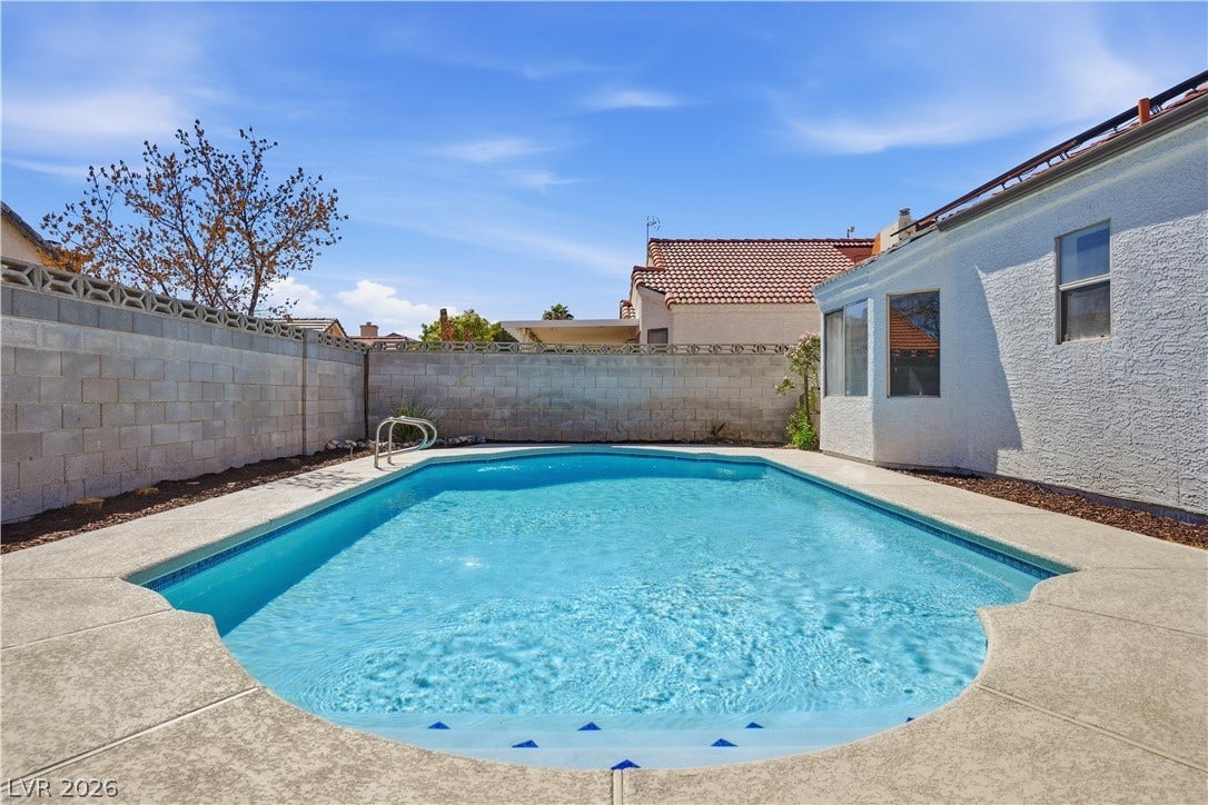 1013 Greystone Drive, Las Vegas, NV 89108 Concrete decking surrounds a private swimming pool set within a secure, walled backyard.