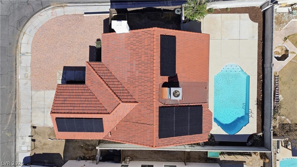 1013 Greystone Drive, Las Vegas, NV 89108 An aerial perspective showcases the tile roof, solar panels, and sparkling backyard pool.