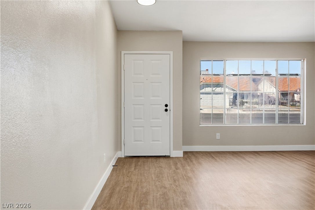 1013 Greystone Drive, Las Vegas, NV 89108 A spacious entryway welcomes guests with clean lines, smooth plaster walls, and durable wood flooring.