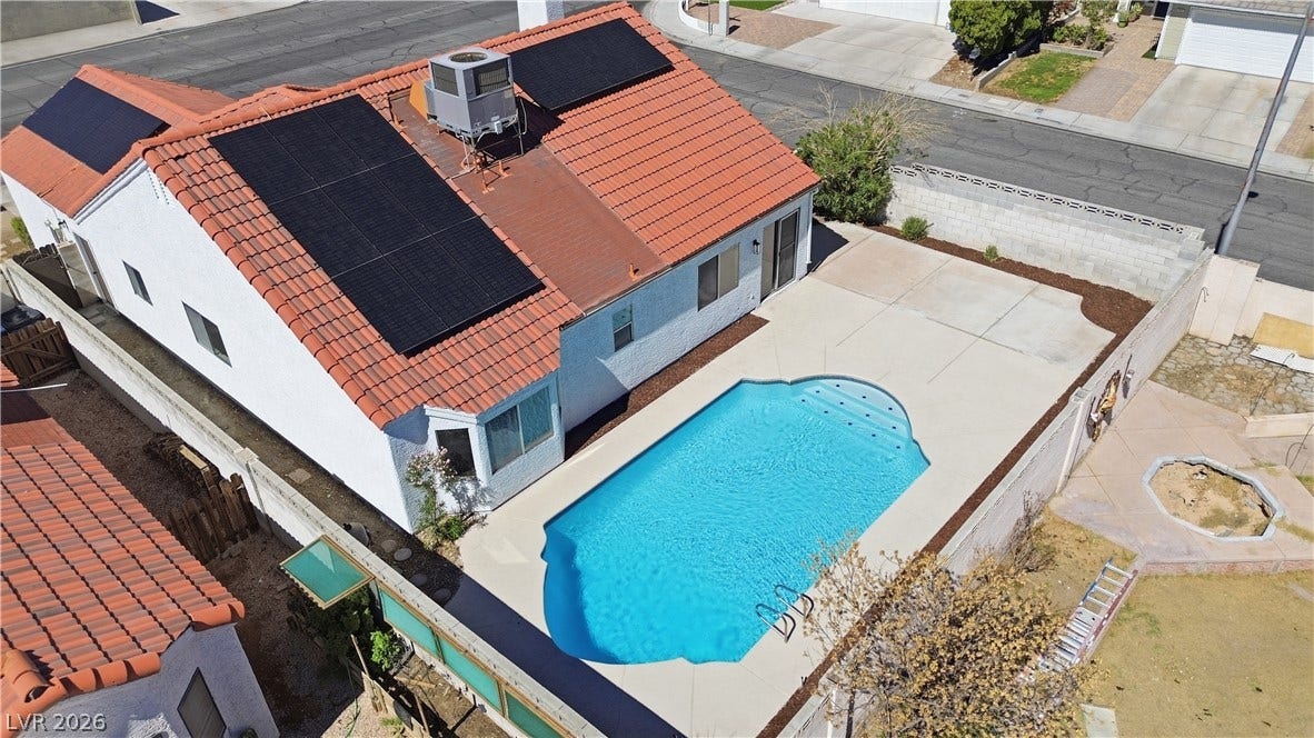 1013 Greystone Drive, Las Vegas, NV 89108 A private swimming pool and concrete patio highlight this backyard setup.