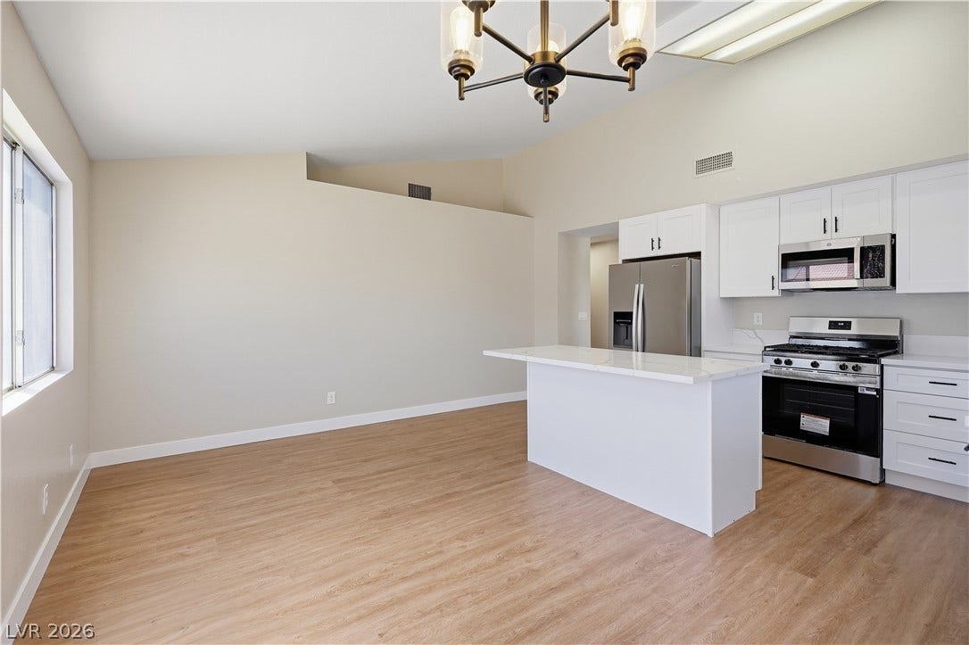 1013 Greystone Drive, Las Vegas, NV 89108 Clean lines and a spacious layout define this modern kitchen with vaulted ceilings.