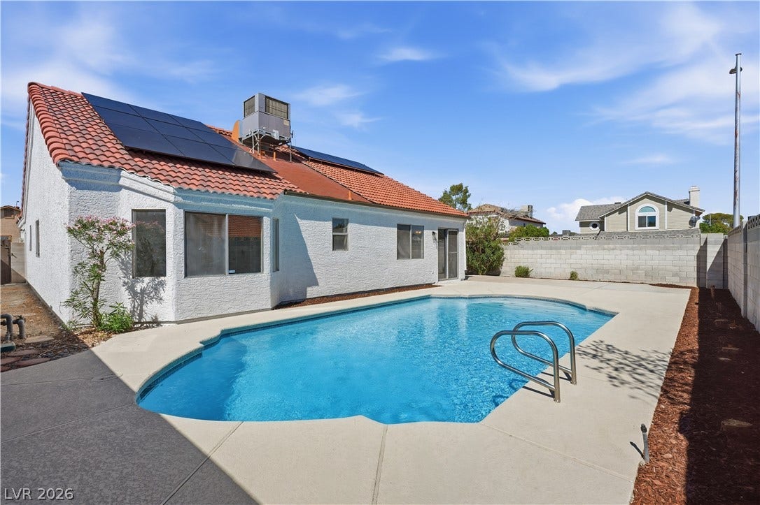 1013 Greystone Drive, Las Vegas, NV 89108 An inviting swimming pool anchors this private backyard setting surrounded by concrete decking and high privacy walls.