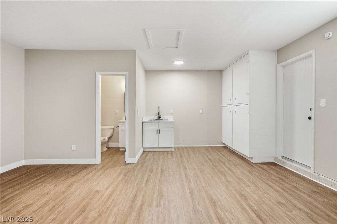 1013 Greystone Drive, Las Vegas, NV 89108 Clean wood-look flooring stretches across a versatile bonus room complete with a utility sink.