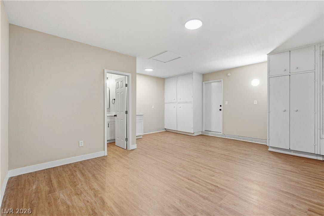 1013 Greystone Drive, Las Vegas, NV 89108 Ample built-in storage cabinets and smooth wood-style flooring define this versatile multi-use space.