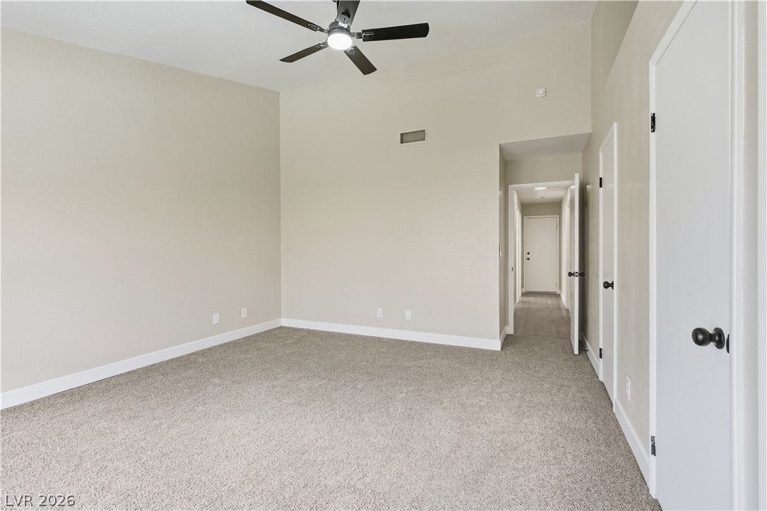 1013 Greystone Drive, Las Vegas, NV 89108 High ceilings and neutral carpet create a quiet atmosphere in this light-filled room.