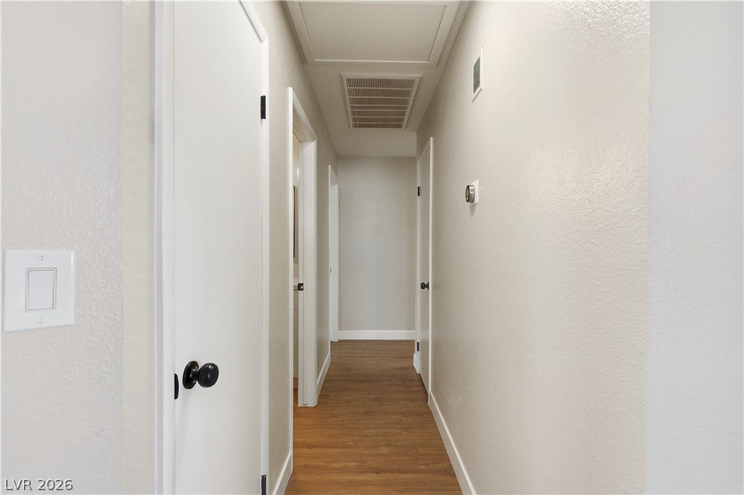 1013 Greystone Drive, Las Vegas, NV 89108 Smooth wood flooring runs the length of this clean, well-lit hallway.