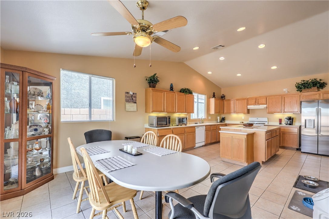 Vaulted ceilings and tile flooring enhance this open-concept culinary space.