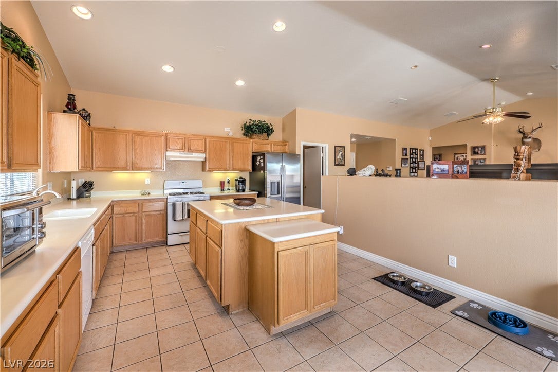 Ample cabinetry and tile flooring define this functional kitchen layout.