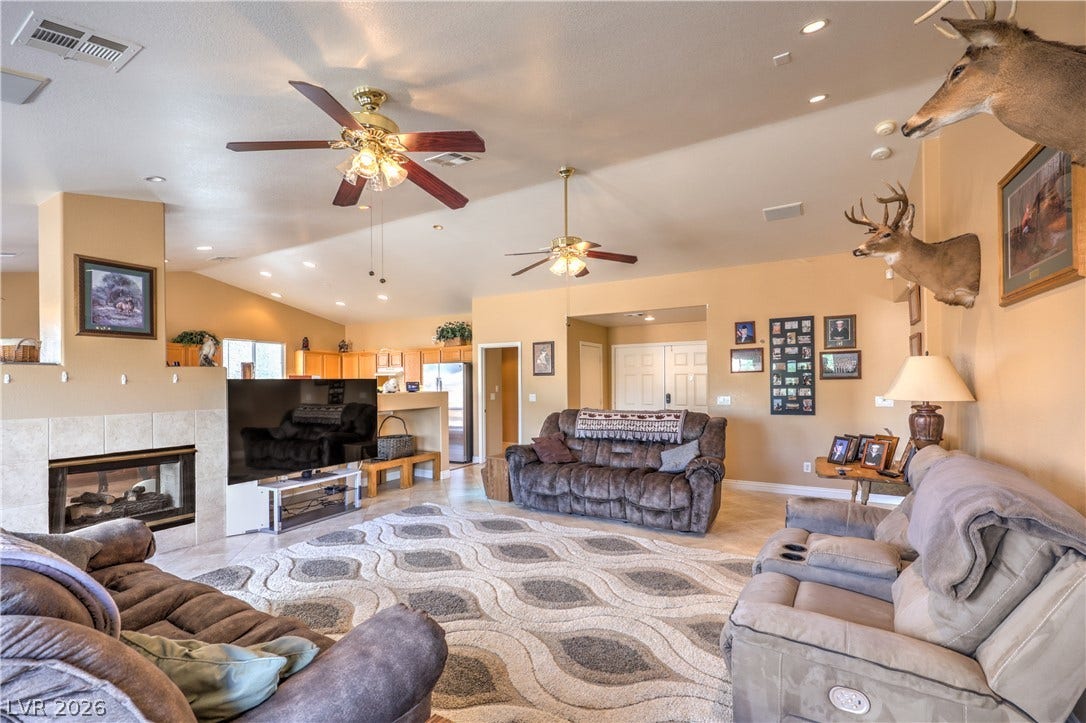 An open floor plan connects the tiled living room to the nearby kitchen.