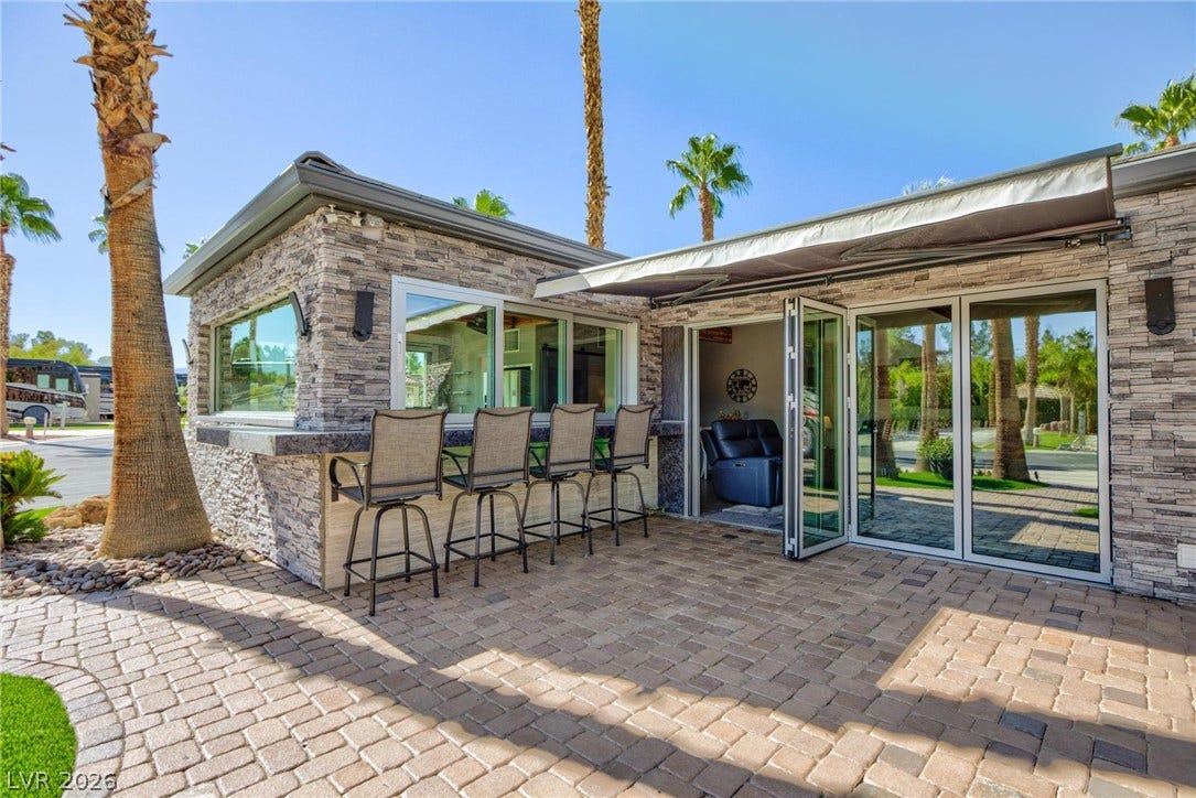 8175 Arville Street, #142, Las Vegas, NV 89139 An inviting stone-clad patio bar and seating area under a retractable awning.