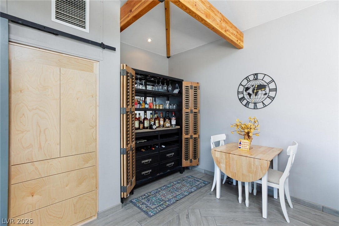 8175 Arville Street, #142, Las Vegas, NV 89139 Exposed ceiling beams and herringbone pattern flooring anchor this stylish dining nook.